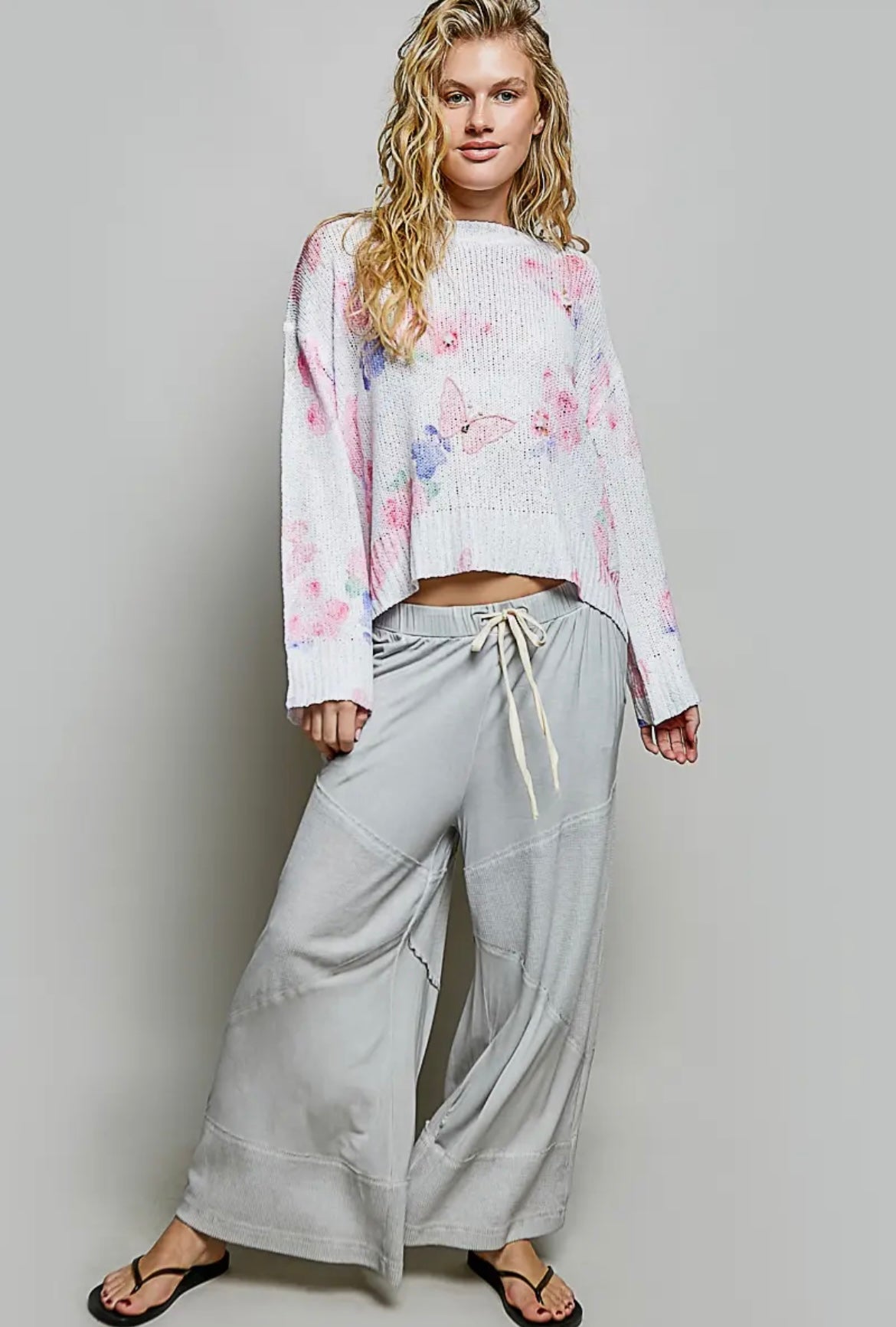 POL, ivory butterfly print sweater with sequin flower details.