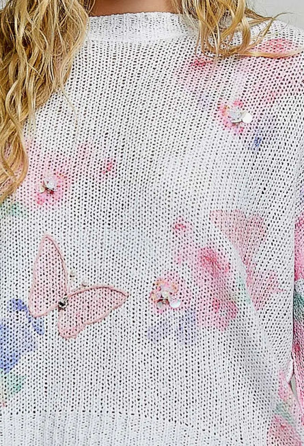 POL, ivory butterfly print sweater with sequin flower details.