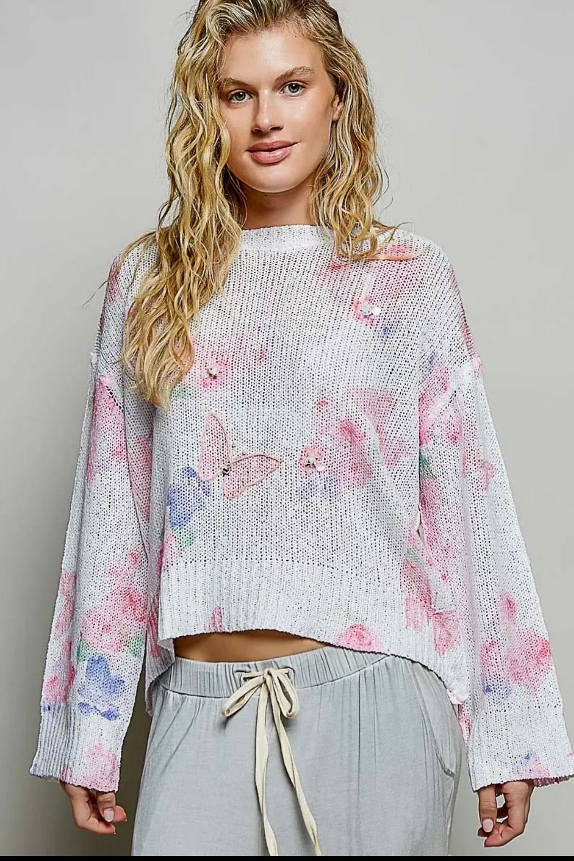 POL, ivory butterfly print sweater with sequin flower details.